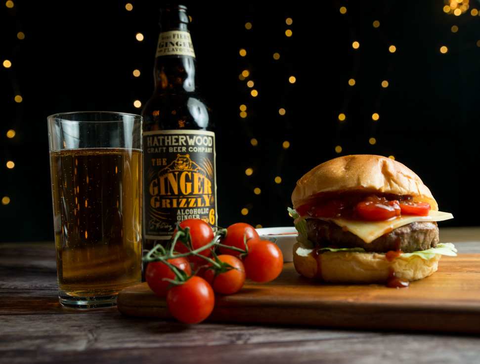 Food photography: Cheeseburger with relish, vine tomatoes and craft beer